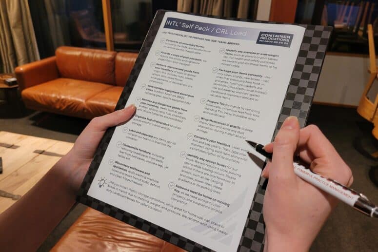A picture of someone holding a checklist for a move to Australia