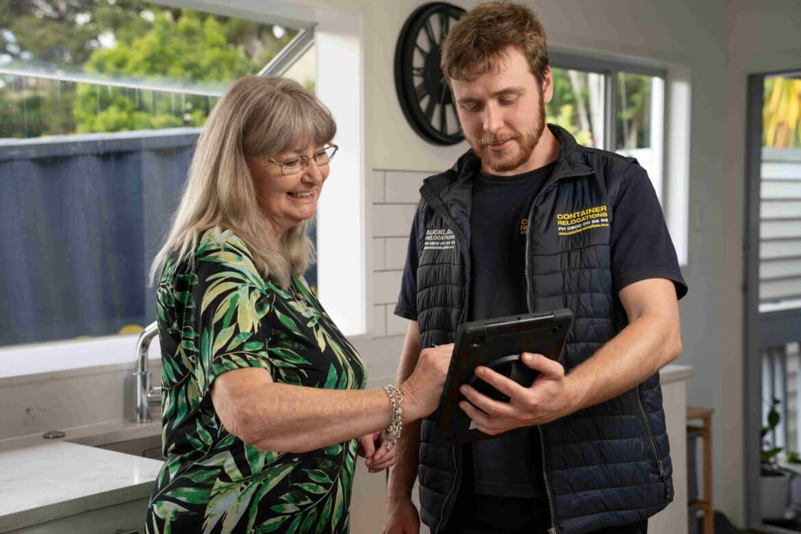 Happy customer signing a consignment note on a tablet