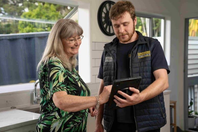 Happy customer signing a consignment note on a tablet